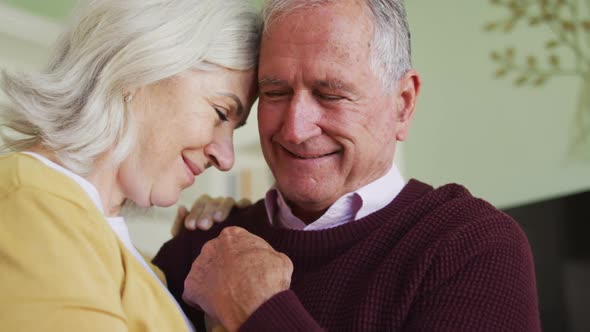 Happy senior caucasian couple embracing and slow dancing togther alt