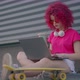 A Pink Curly Girl is Working or Studying on Laptop Outdoors - VideoHive Item for Sale