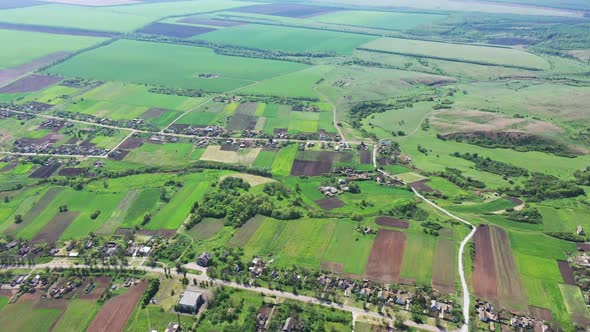 A bird's eye view of the village and spring fields.