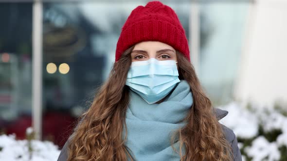 Curly Brunette Woman in Surgical Protective Mask for Corona Virus Second Outbreak Prevention