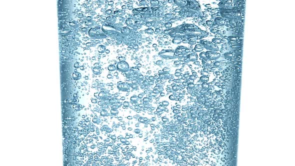 Sparkling Water into Glass against White Background, Slow Motion alt
