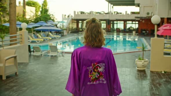 a Young Woman in a Vintage Bathrobe Goes to the Hotel Pool alt
