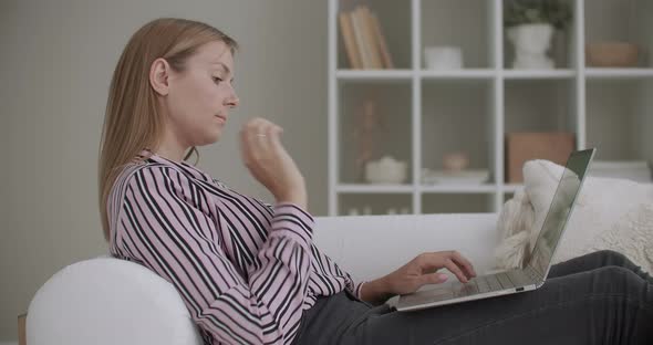 Young Pretty Woman Is Communicating in Social Nets, Typing and Sending Message on Laptop with alt