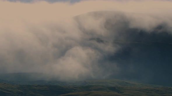 Clouds swirling down over Mallerstang Edge in the Westmorelanddales driven by a strong east wind. alt