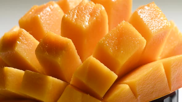 Closeup View of Rotating Sliced Mango Fruit alt