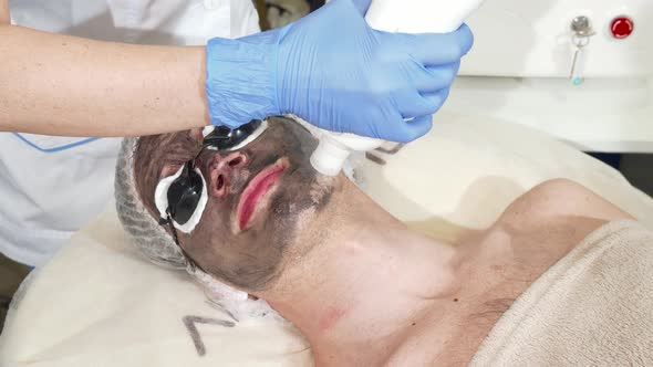 Cosmetologist Doing Facial Carbon Peeling for Male Client alt