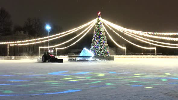 Tractor Cleaning Ice From Now on Ice Rink Decorated for Christmas