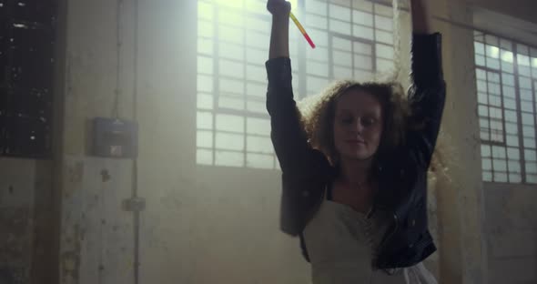 Fashionable young woman in an abandoned warehouse alt