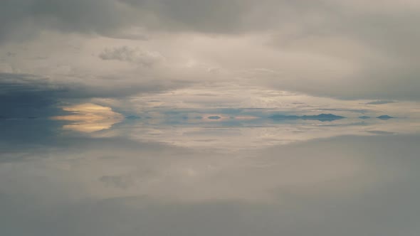 Drone sunset of Salar De Uyuni reflection water salt lake, desert in Bolivia 4K
