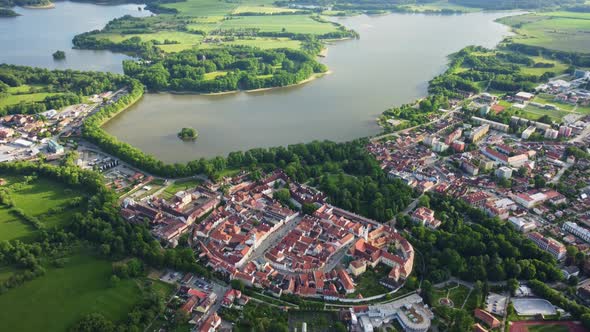 Aerial view of a large muddy pond near the historic town of Trebon surrounded by protected landscape alt