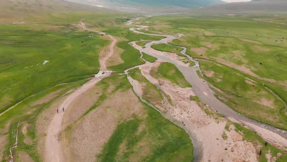 Bicyclist Ride on Assy Mountain Valley in Kazakhstan alt
