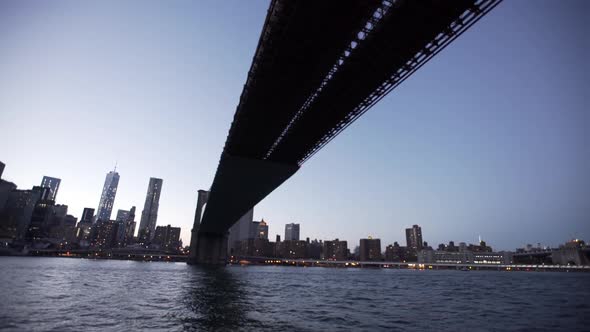 Drone view moving under the Brooklyn Bridge, New York City, New York, USA