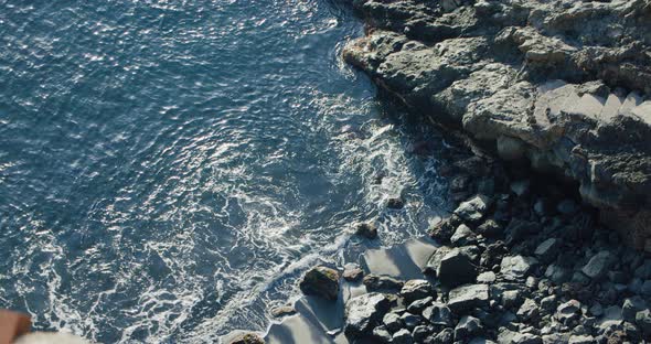 Ocean Waves Crashing on Volcanic Stones at Sunrise alt
