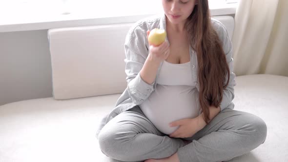 Authentic Cute Pregnant Woman Feeling Happy at Home with Belly