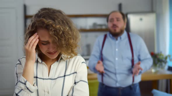 Overweight Man Shouting at Young Crying Wife at Home alt