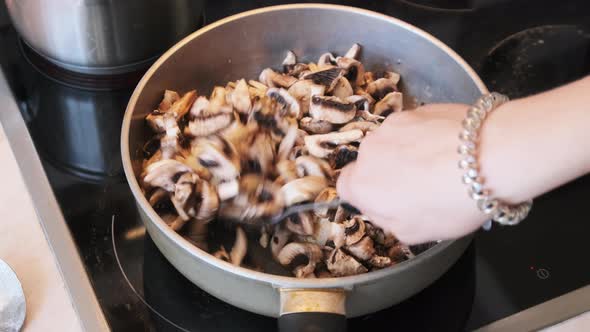 Mushrooms are Fried in a Pan in the Home Kitchen Cooking Mushrooms Julienne alt