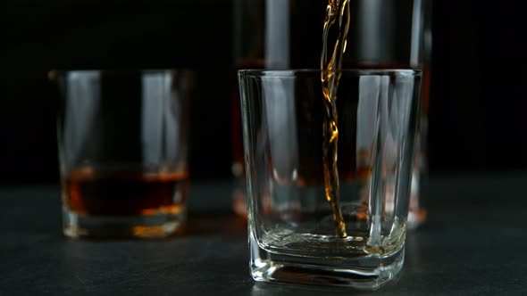 Super Slow Motion Shot of Pouring Whiskey Into Glass at 1000Fps with Camera Movement alt