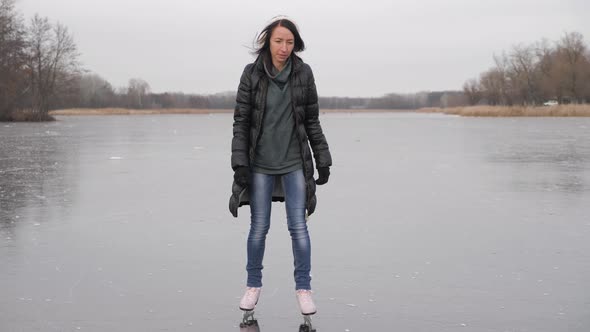 Young Woman Ice Skating on a Frozen Lake on a Freezing Winter Day. People, Winter Sport and Leisure alt