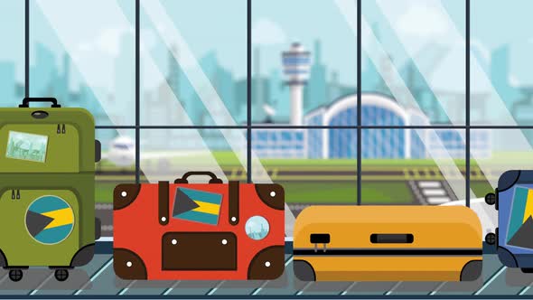 Suitcases with the Bahamian Flag Stickers on Baggage Carousel alt