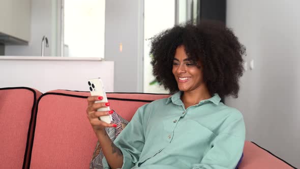 Happy AfricanAmerican Female Using Mobile App on Smartphone for Making Video Call