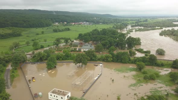 Aerial View of the Overflowing River. Flooded Buildings and Roads. Extremely High Water Level in the