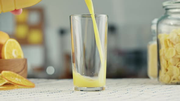 Woman Pouring Orange Juice Fresh Juice on Kitchen Table Vitamin c Cooking Drink Made of Citrus alt