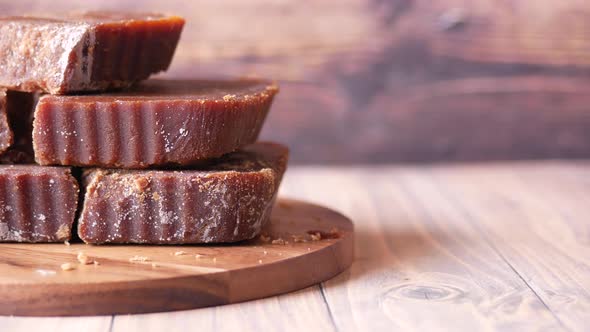 Stack of Jaggery Traditional Cane Sugar Cube on Table alt