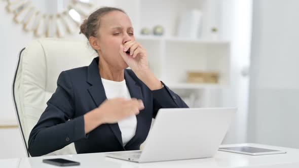 Sick African Businesswoman with Laptop Coughing in Office alt