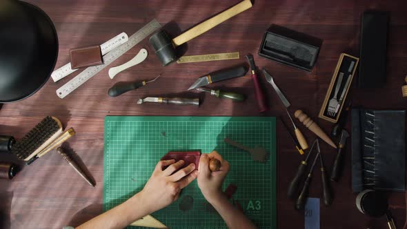 Craftsman Working with Brown Leather Using Professional Tools and Ruler on Table at Workshop alt