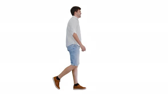 Casual Young Man Walking and Looking Forward on White Background. alt