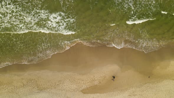 Tourist On Sandy Beachfront With Breaking Waves From Ocean In Wladyslawowo, Northern Poland During S alt