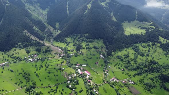 Aerial photography using a drone from a high altitude of a village surrounded by forests and natural