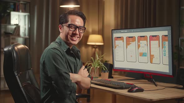 Asian Male Mobile Application Developer Works With Graphics On His Personal Computer alt