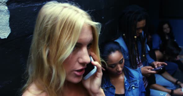 Young friends texting and talking on the phone, 4K 4k alt