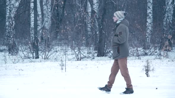 Man Walking in a Winter Forest alt