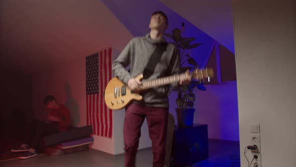 Energetic Young Man Playing Rock Music on Guitar