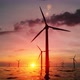 Wind Turbines Silhouettes Spinning In An Offshore Wind Farm In The Ocean Against The Sunset - VideoHive Item for Sale