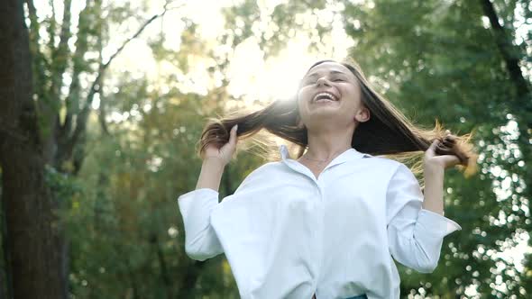 Close Up Portrait of Young Brunette Girl Smiling. Happy Awesome Woman with Hair Blowing in Wind alt