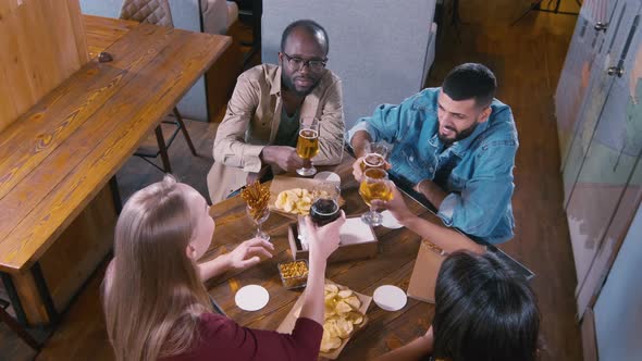 Friends clinking glasses in bar