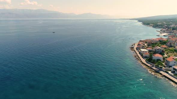 Aerial view of boat sailing Sutivan coastal line during the summer, Croatia. alt