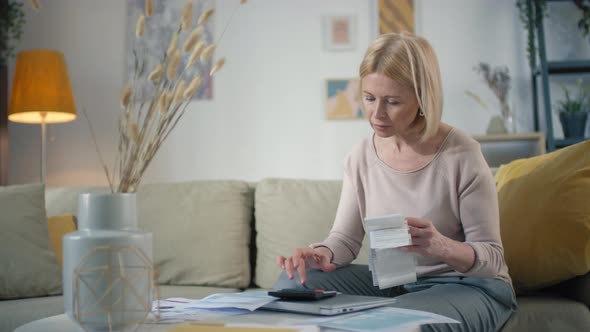 Woman Calculating Monthly Bills alt