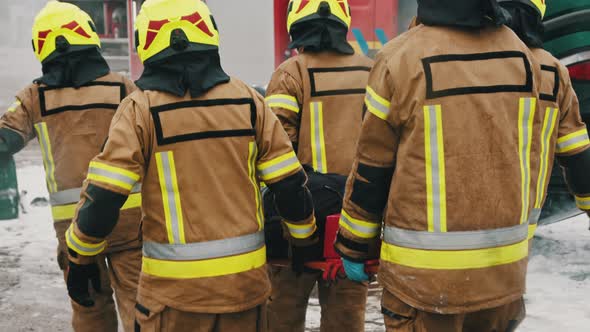 Firefighters Rescuing Injured Person After the Car Accident. Slow Motion alt