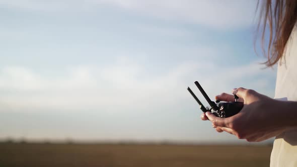 Drone Controller in Women's Hands Against a Beautiful Sky. Copyspace for Your Text