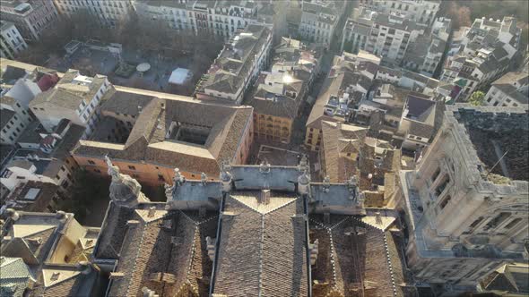 Slow tilt-down aerial reveal of square in front of Granada Cathedral