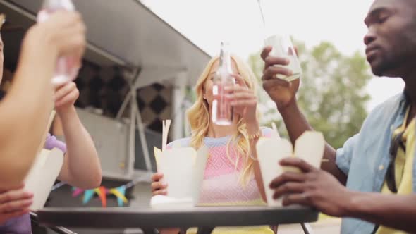 Friends Clinking Bottles of Drinks at Food Truck 40 alt