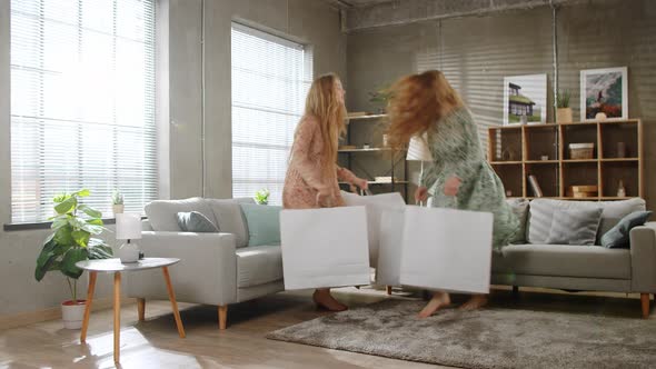 Two Young Sisters Twins are Returned Home From the Store with Large White Shopping Bags alt