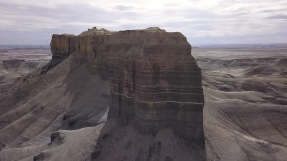 Aerial view circling tall rock spires in the desert alt