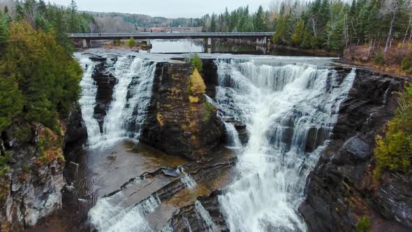 Cliff between two waterfalls with a bridge in Kaministiquia River, Kakabeka Falls, Ontario, Canada alt