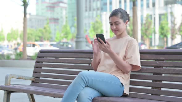 Indian Woman Browsing Internet on Smartphone in Office alt