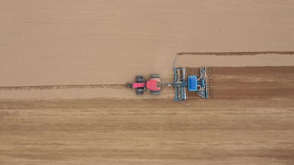 Tractor Drill Plows And Seeder Plants Seeds Of Grain Crops In Agricultural Field alt